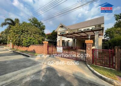 Front view of a house with a gate and driveway