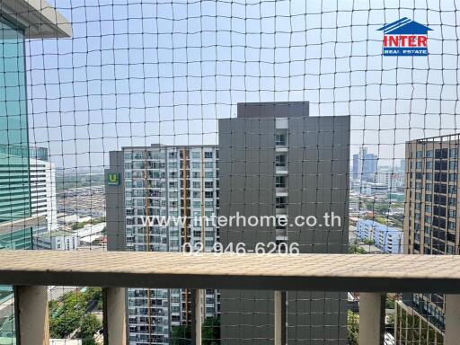 View from a balcony with high-rise buildings in the background