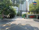 Entrance of a residential building with a driveway and greenery