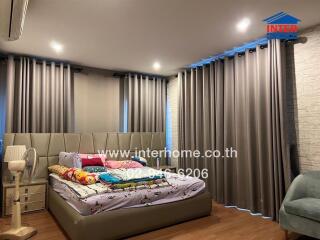 Cozy bedroom with modern furnishings and ample natural light.