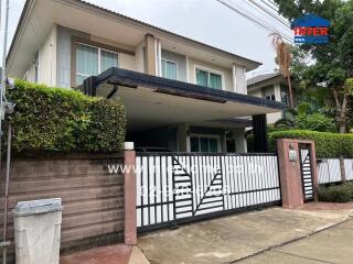 Front view of a two-story house with a gated entrance