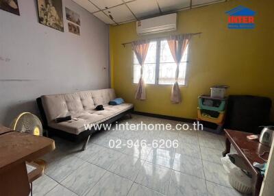 Living room with sofa and wall air conditioner