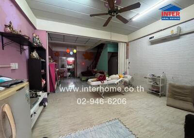 Living room with furniture, ceiling fan, and air conditioning unit