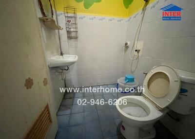 Bathroom with sink, toilet, and shower area