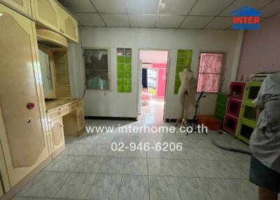 Room with cabinets, tiled floor, and decorative art pieces