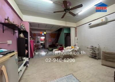 Spacious living room with ceiling fan and air conditioning unit