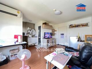 Living room with various furnishings and appliances