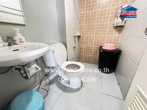 Clean and functional bathroom with sink, toilet, and shower.