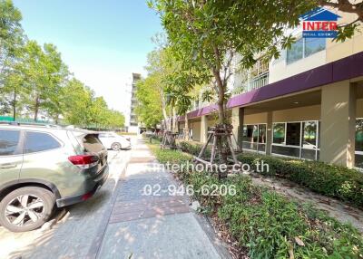 Front view of residential building with walkway and parked cars