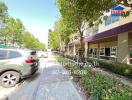 Front view of residential building with walkway and parked cars