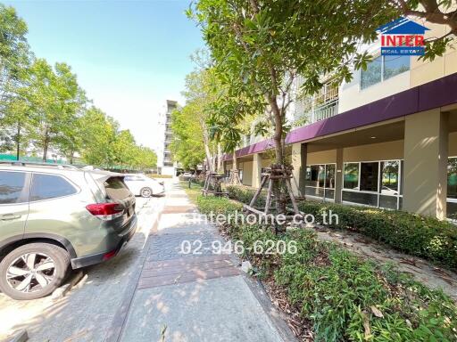 Front view of residential building with walkway and parked cars