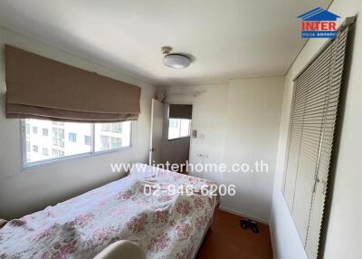 Bedroom with bed, window, and light fixture