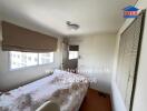 Bedroom with bed, window, and light fixture