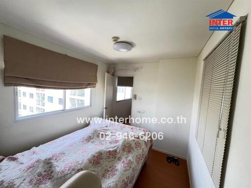 Bedroom with bed, window, and light fixture