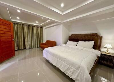 Spacious bedroom with a large bed and soft lighting