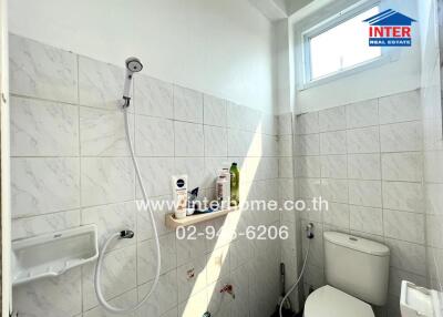 Bathroom with showerhead and toilet