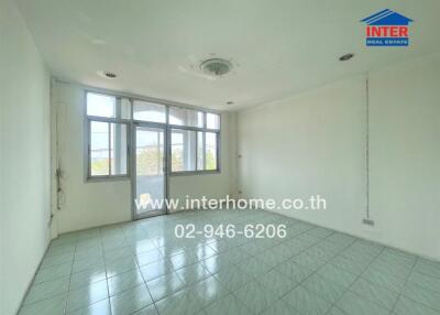Empty room with tiled flooring and large windows