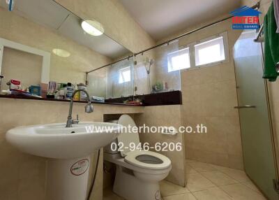 Bathroom with a sink, toilet, and shower area