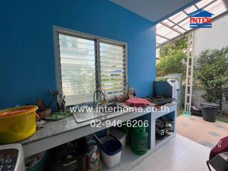 Modern kitchen with blue walls and outdoor access