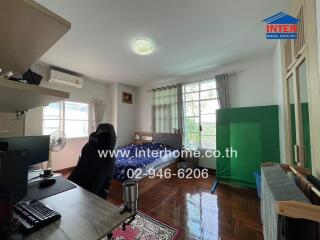 Bedroom with desk, bed, and window