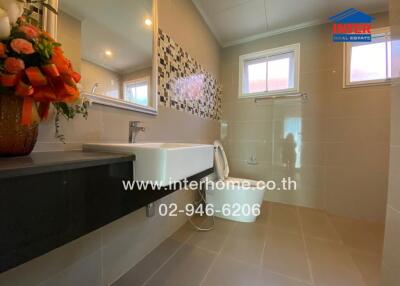 Modern bathroom with vanity, sink, and windows