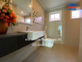 Modern bathroom with vanity, sink, and windows