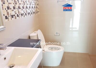 Modern bathroom with sink, toilet, and decorative tiles