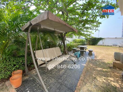 Garden with swing and outdoor seating area