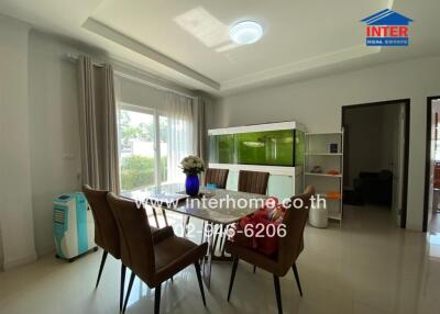 Dining room with large window, fish tank, and air cooler