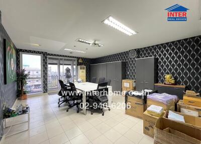 Spacious office room with modern lighting and ample storage