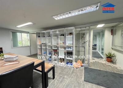Modern office space with glass partitions and shelves