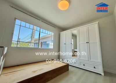 Bedroom with a large window and built-in wardrobe