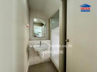 Small bathroom with wall-mounted sink and mirror