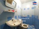 Blue-tiled bathroom with sink, toilet, and shower