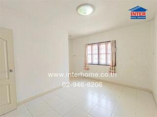 Empty bedroom with a window and curtain, white tiled floor