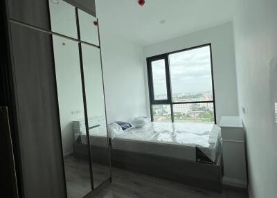 Bedroom with large window and mirrored wardrobe