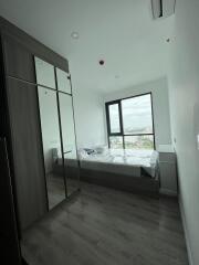 Bedroom with large window and mirrored wardrobe