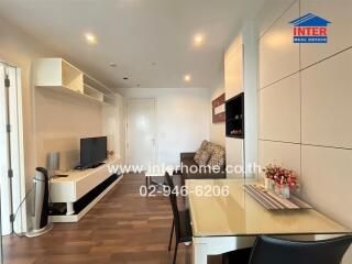 Modern living room with dining space and entertainment setup