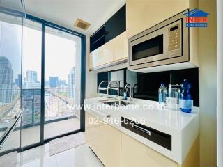 Modern kitchen with city view, featuring built-in appliances