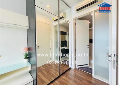 Modern bedroom with mirrored closet doors and wooden flooring