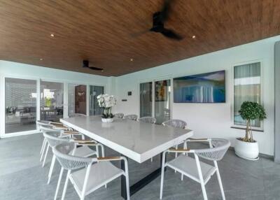 Spacious dining area with a modern table, chairs, and decorative elements