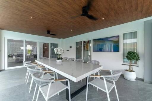 Spacious dining area with a modern table, chairs, and decorative elements