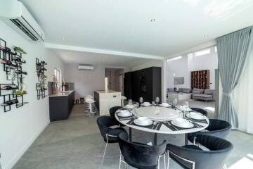 Modern open-plan dining and living area with a kitchen