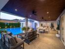 Spacious outdoor patio with seating and dining area overlooking a swimming pool