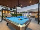 Outdoor leisure area with pool table, swimming pool, and lounge seating