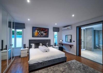 Spacious bedroom with modern decor and en suite bathroom