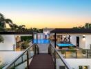 Modern outdoor area with pool and recreational spaces at sunset