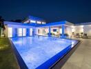 Modern house with illuminated swimming pool at night