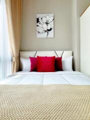 Cozy bedroom with a bed, pillows, and wall art