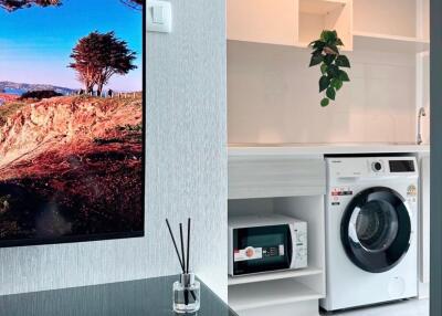 Modern laundry room with washing machine and cabinets